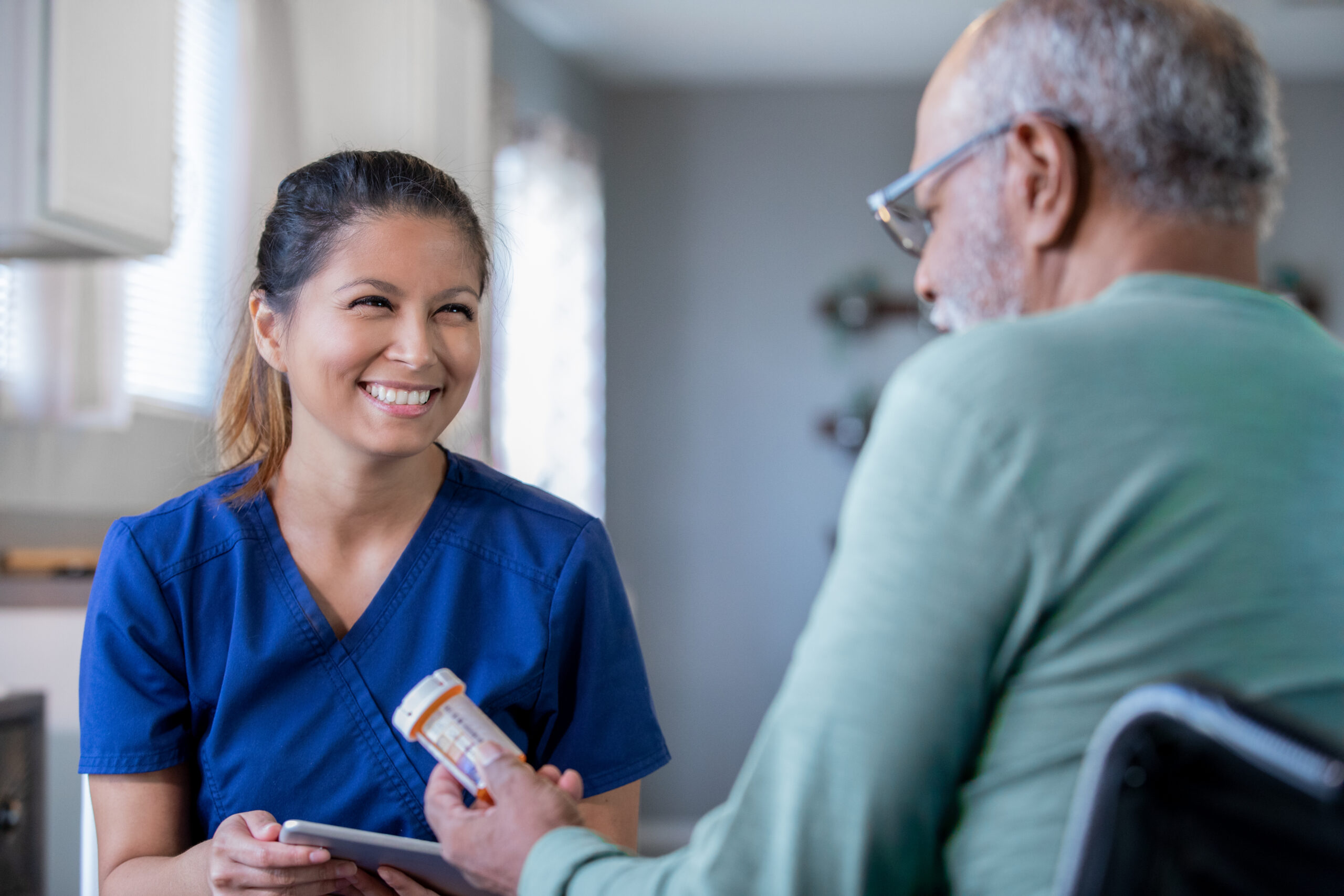 Home healthcare nurse brings new prescriptions for senior man