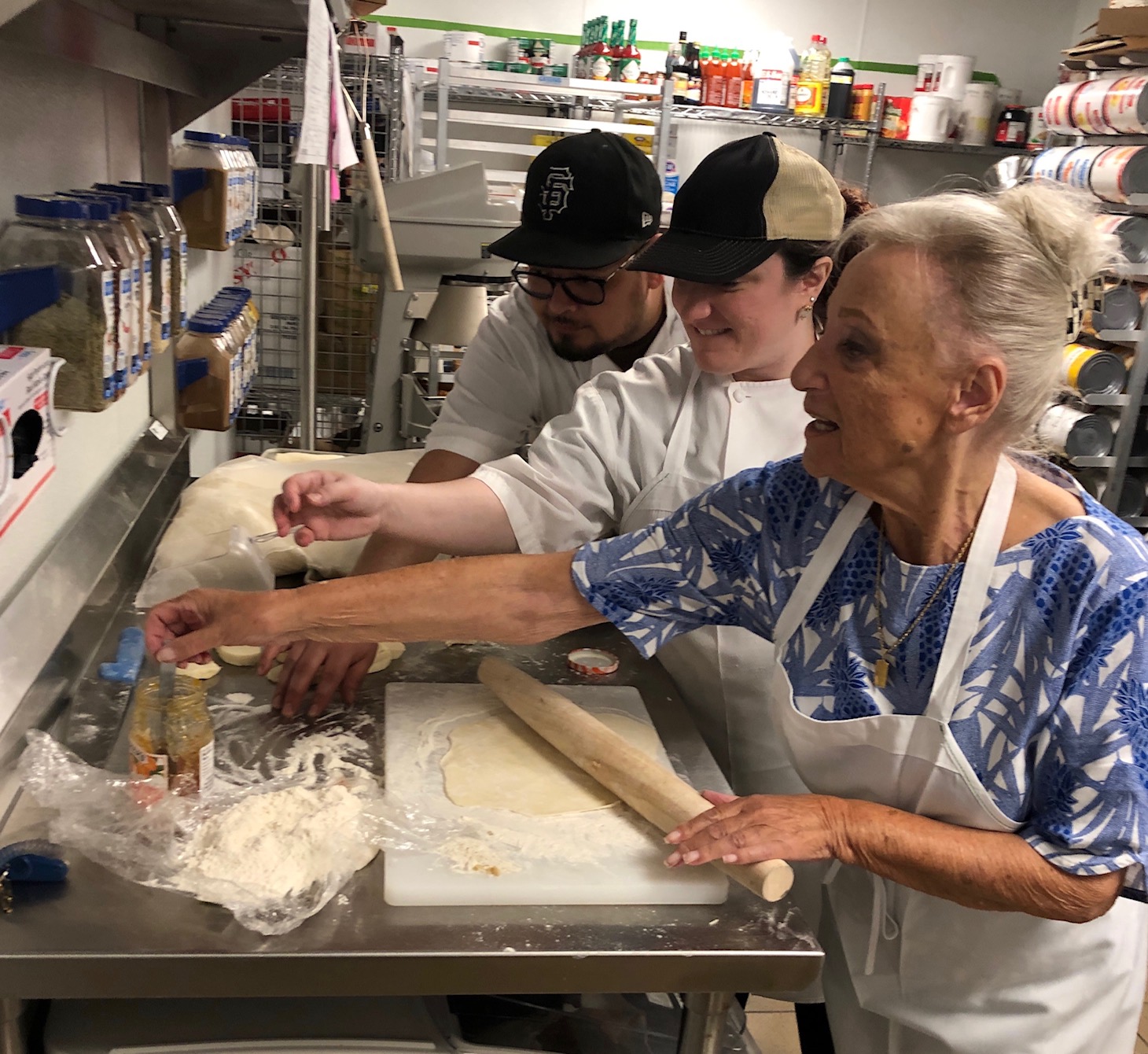 Senior working with kitchen staff to make dinner